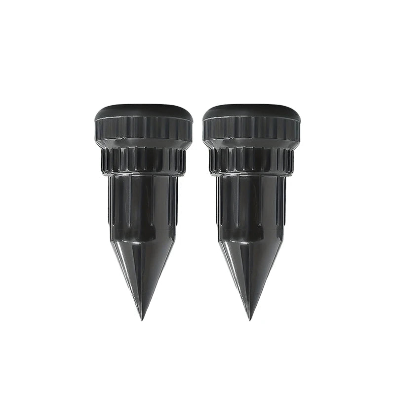 A pair of black realistic watering can key hiders for outdoor security.