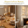 Golden candlesticks illuminating a dining table setting with elegant candlelight.