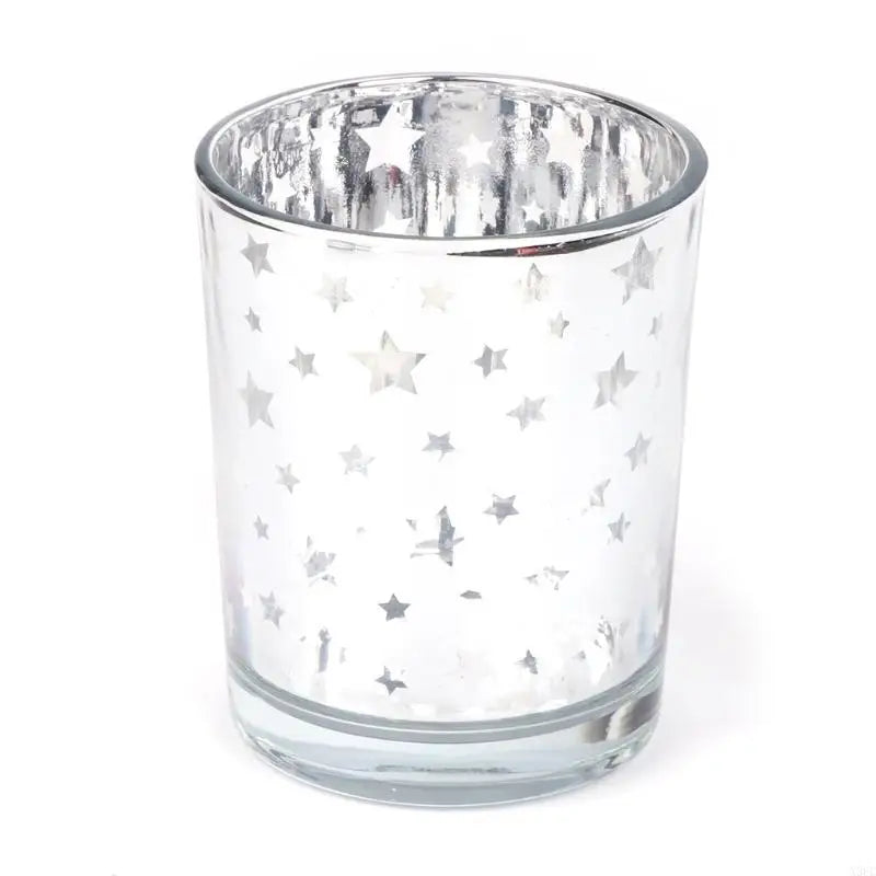 A clear glass votive candle holder decorated with silver stars.