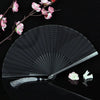 A black titanium alloy folding hand fan with a sheer mesh surface is displayed against a dark background.