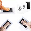 A kit showing various handprints and footprints made by a baby, including a foot print and a hand print.