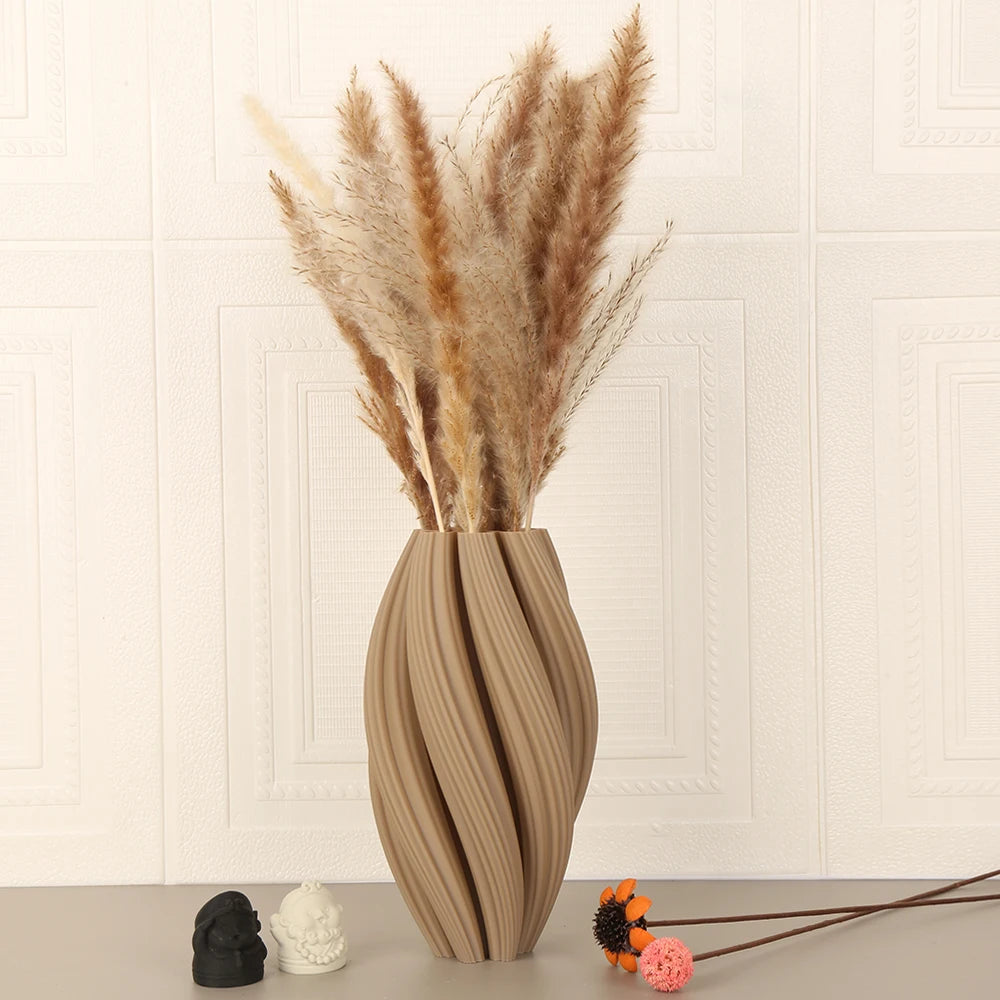A tall arrangement of dried pampas grass in a textured wave vase with soft beige tones.