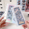 A hand holds a vertical transparent card organizer filled with multiple photocards and cards.