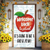 A vertical vinyl backdrop banner featuring an apple graphic and text welcoming people back to school surrounded by sunflowers