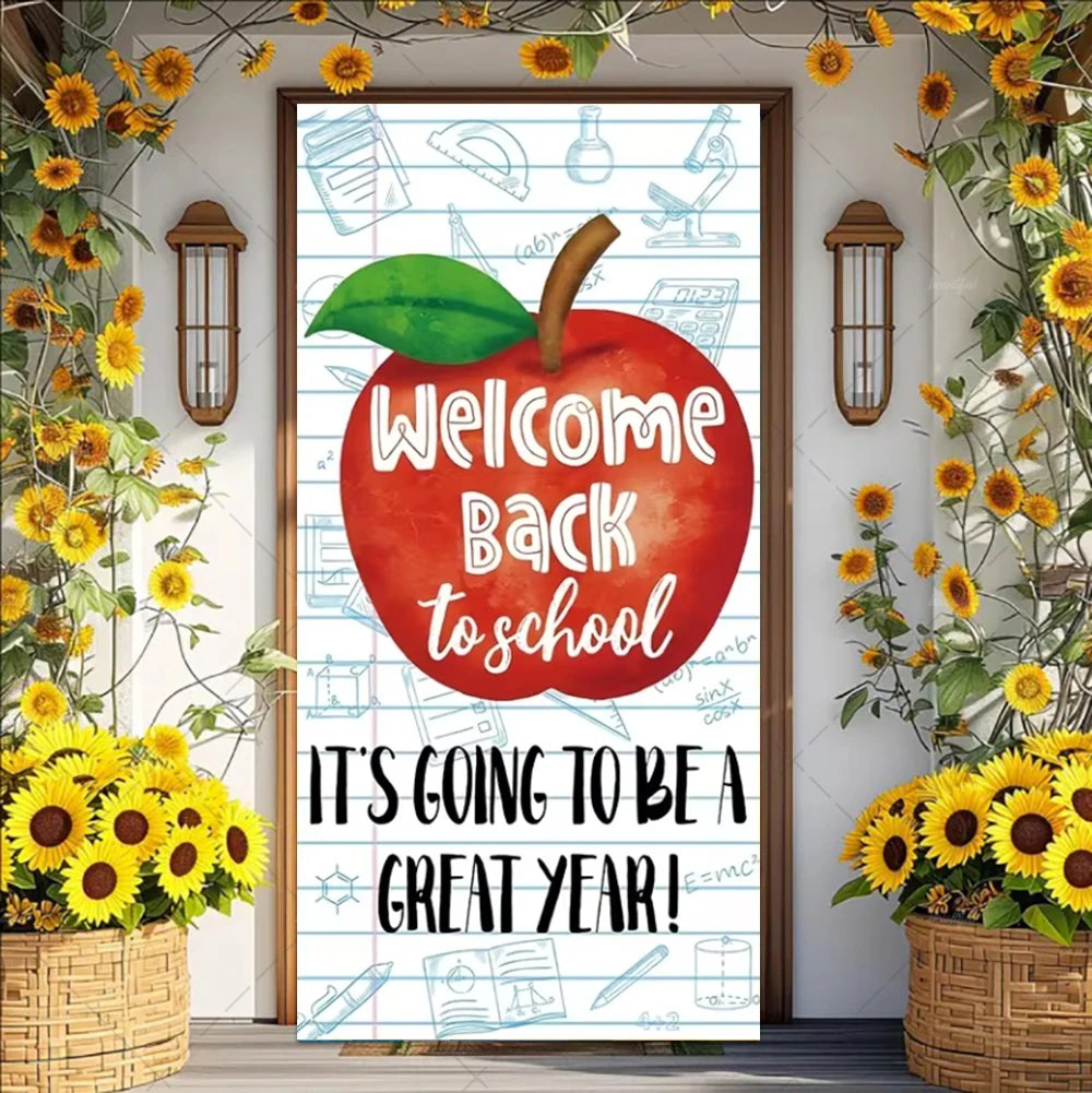 A vertical vinyl backdrop banner featuring an apple graphic and text welcoming people back to school surrounded by sunflowers