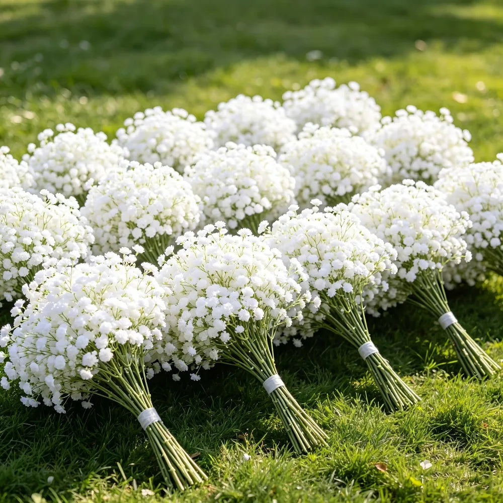 A bouquet of white baby's breath flowers arranged on green grass.