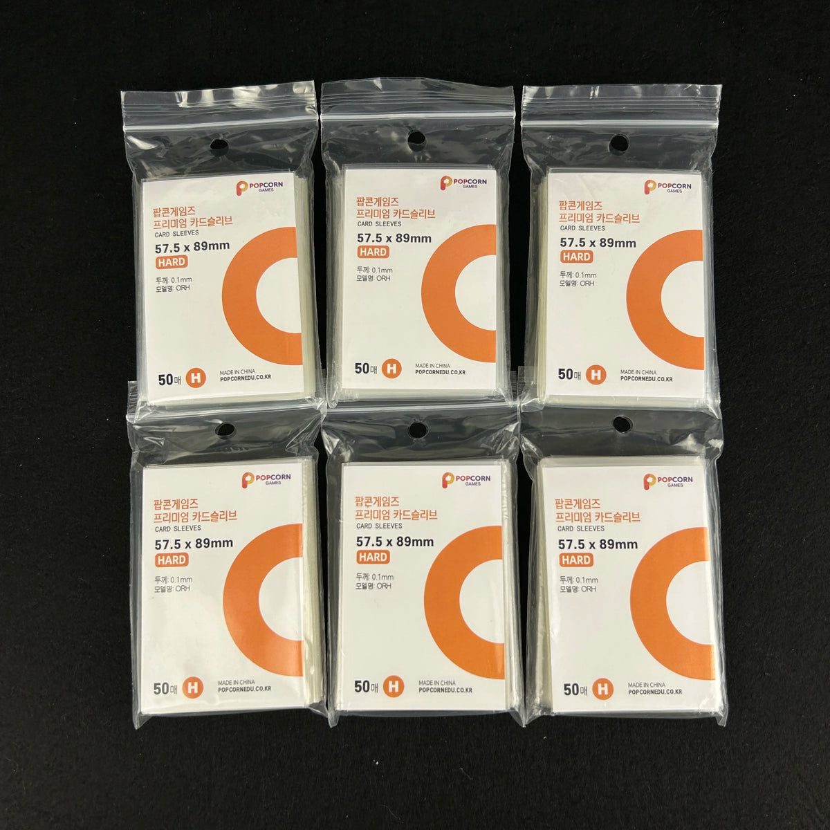 A grid of ten clear plastic card sleeves packaged in individual sealed pouches for protection.