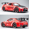 A red Nissan GT-R sports car diecast model with black accents and racing decals displayed on a white surface.