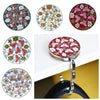 A collection of floral crystal handbag hooks in various colors and designs mounted on a silver metal ring.