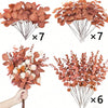 Dried eucalyptus leaf stems in shades of terracotta and rust arranged in bundles for decor