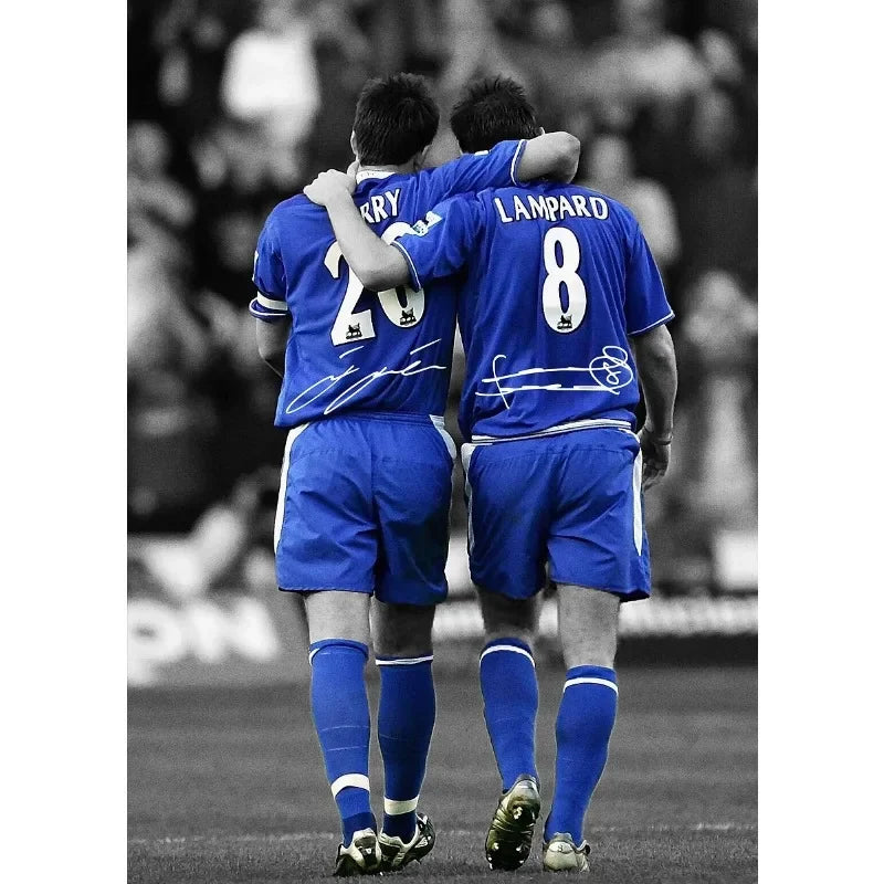 Two soccer players in blue jerseys stand side by side on a field.