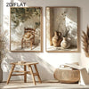 Two framed botanical canvas wall art pieces featuring olive branches and natural textures displayed in a bright interior.