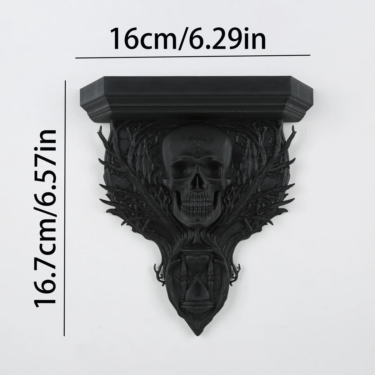 A black ornate gothic wall shelf featuring intricate carvings of a skull and foliage.
