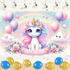 A magical pink unicorn character surrounded by balloons and flowers on a birthday party backdrop.