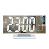 A digital projection alarm clock displaying 7:00 AM and a PM indicator on a white surface.