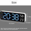 A digital wall clock displaying the time 20:38, temperature 23°C, and showing various days of the week.