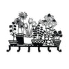 Black decorative metal key hooks arranged in a linear display for wall organization