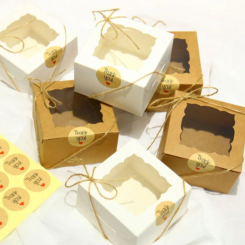 Kraft paper favor boxes with natural twine tied around them, featuring a thank you tag.