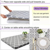 A gray elastic fitted rectangle tablecloth is shown being used on a table, with a close-up of the fabric pattern and a decora