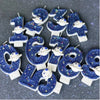 Twelve blue glitter candles shaped like numbers 1 through 9 featuring white space marine designs