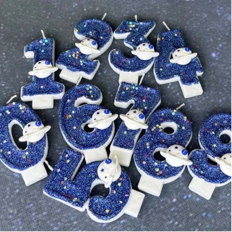 Twelve blue glitter candles shaped like numbers 1 through 9 featuring white space marine designs