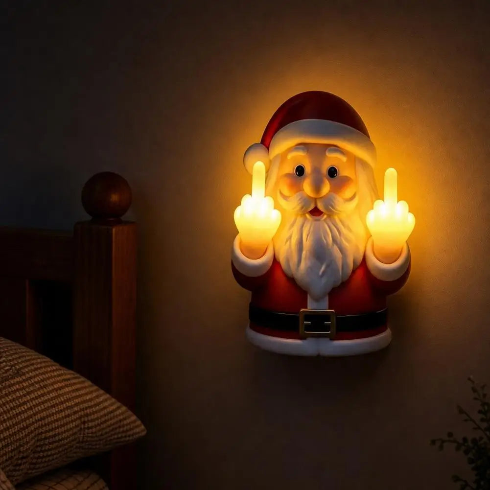 A glowing Santa Claus night light depicting a bearded face making a middle finger gesture, mounted on a wall.