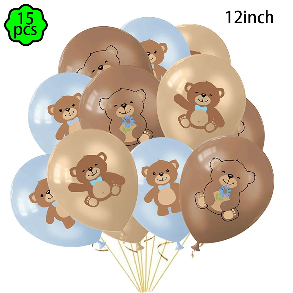 A bunch of 15 gold and light blue balloons featuring cute teddy bear designs for a birthday party banner.