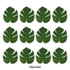 A set of twelve artificial tropical palm leaves in various shades of green for party decor.