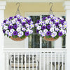A hanging basket filled with purple and white artificial petunia flowers decorating a porch.