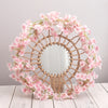 A circular wreath made of pink artificial sakura flowers and a natural wood lattice frame.