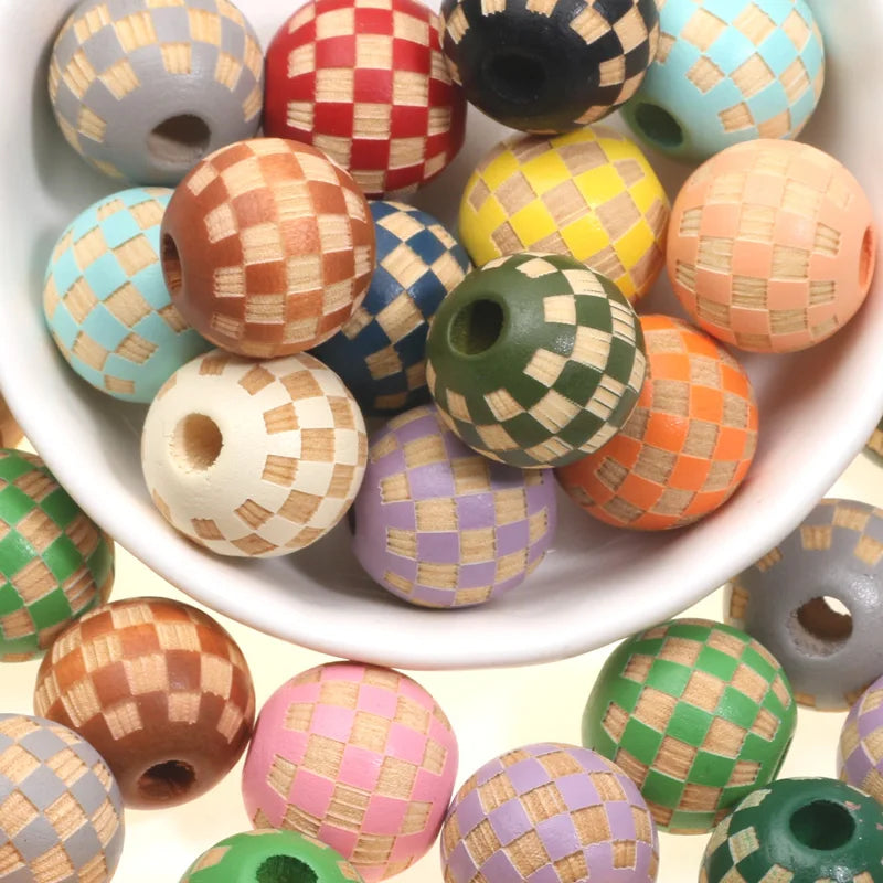 A bowl filled with natural wooden checkered beads in various colors including pink, green, orange, yellow, and blue.