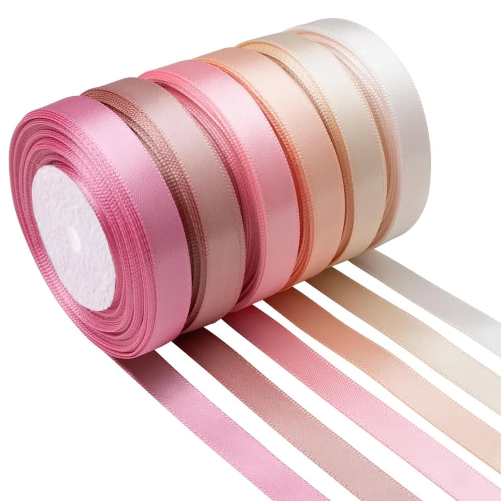 Roll of satin silk ribbon in pink and beige colors shown alongside cut ribbons