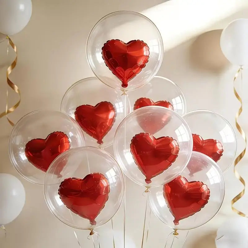 A collection of clear and red heart-shaped foil balloons floating against a light background.