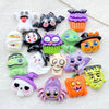 A collection of colorful Halloween resin charms including ghosts, cats, pumpkins, and skulls for DIY crafts.