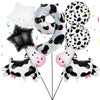 A set of cow print number balloons including the number nine, a soccer ball, and several small cow-themed balloons.