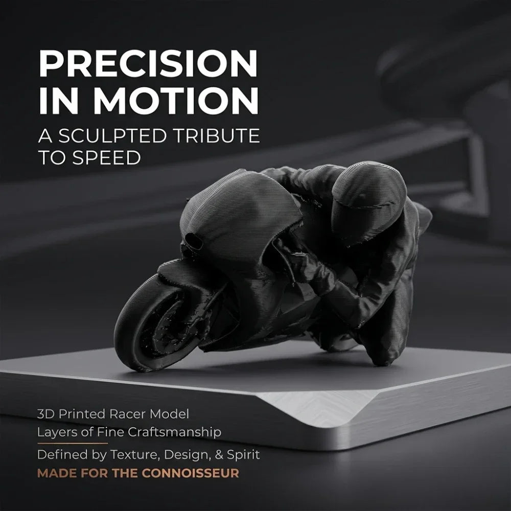 A dark, sculpted figurine of a racing motorcycle rider made from 3D printed material on a gray desk.