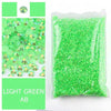 Bag of light green acrylic rhinestones used for craft projects