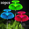 Ten solar jellyfish garden lights in green, blue, and red colors displayed against a green foliage background.