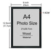 A black wooden picture frame with an A4 photo size insert and a wood material label.