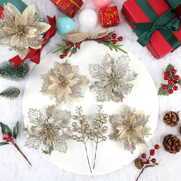 A white plate displays artificial silver and gold floral arrangements and red wrapped gifts on a white fluffy surface.
