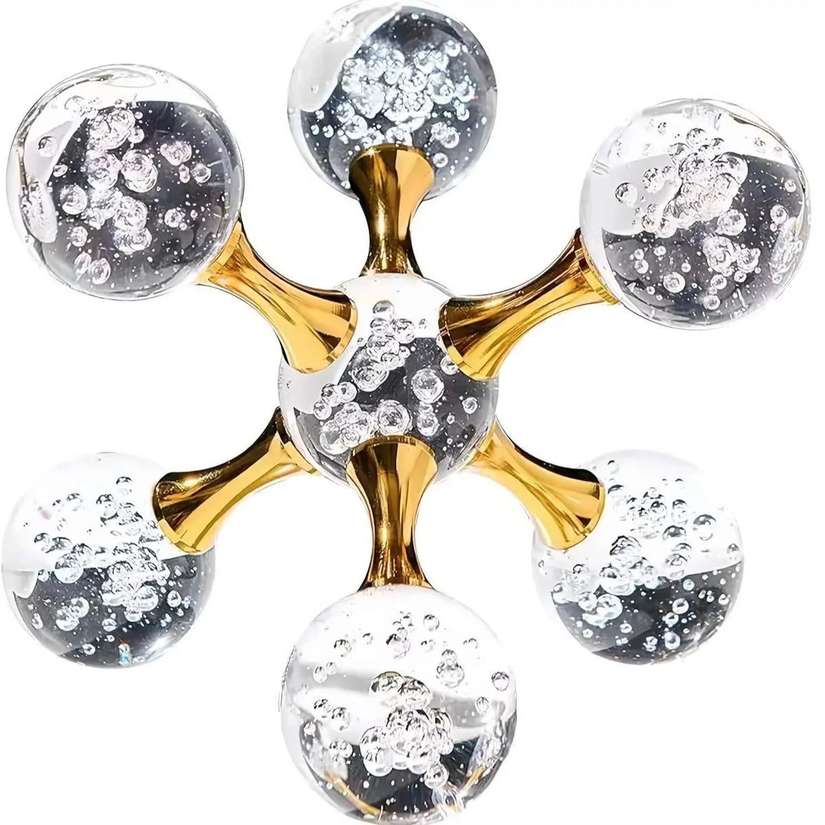 A gold molecular sculpture desk decor featuring spheres of clear and silver glass.