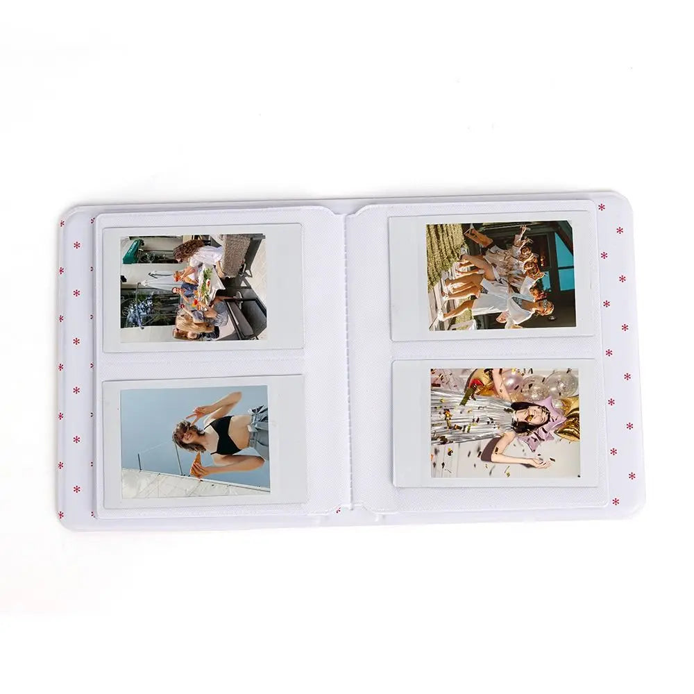 A white photo album with four compartments displaying instant camera pictures.