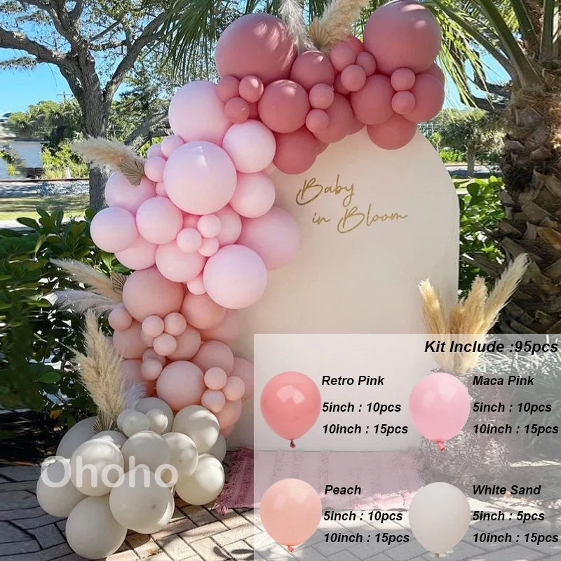 A pink and beige balloon garland arch kit featuring round balloons arranged on a white backdrop.