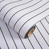Roll of self-adhesive 3D wood grain wall panels with black lines shown diagonally.