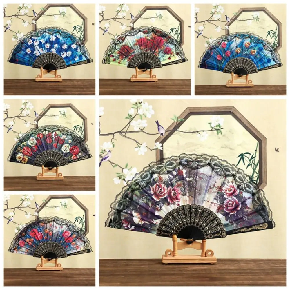 A collection of Spanish style folding lace trim handheld fans in various colors and patterns displayed on a wooden surface.