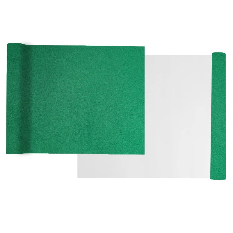 A sheet of green suede wrap fabric is shown next to a white sheet, demonstrating the product.