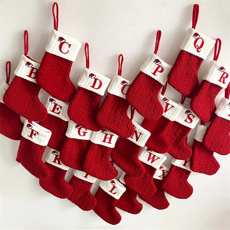A string of red knitted socks shaped like letters of the alphabet for Christmas tree ornaments
