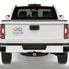 Rear view of a white pickup truck with an Autism Awareness vinyl decal on the tailgate.