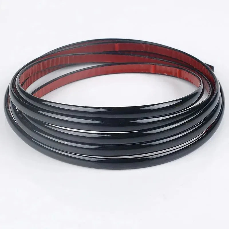 Black and red self-adhesive PVC wall trim tape rolled into a coil.