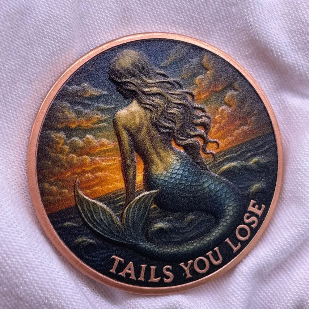 A round copper challenge coin featuring a mermaid design with flowing hair and scales against a sunset background.